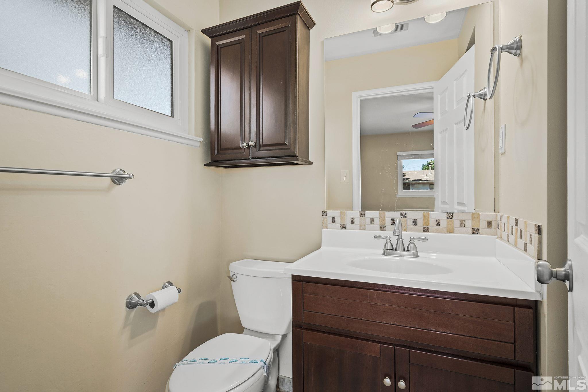 2050 Brisbane Avenue Reno, NV 89503 - Photo 20 of 24 a bathroom with a sink vanity mirror and toilet