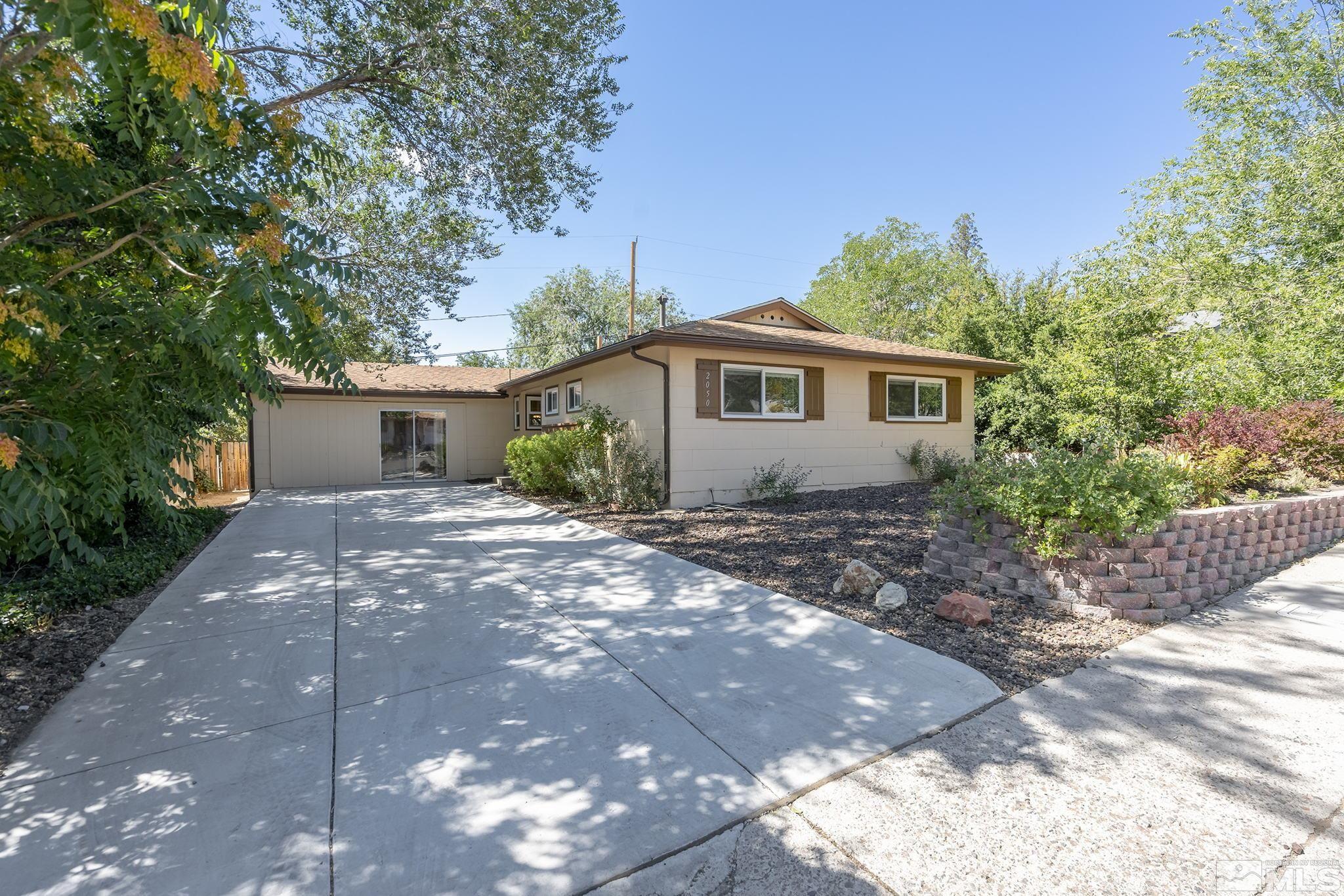 2050 Brisbane Avenue Reno, NV 89503 - Photo 2 of 24 a view of a house with yard and a garden