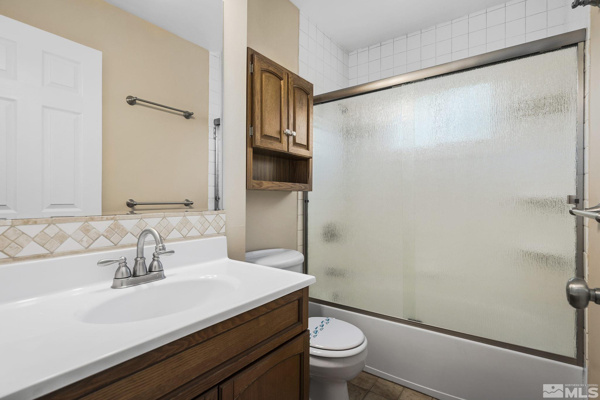 2050 Brisbane Avenue Reno, NV 89503 - Photo 22 of 24 a bathroom with a sink a toilet a mirror and shower