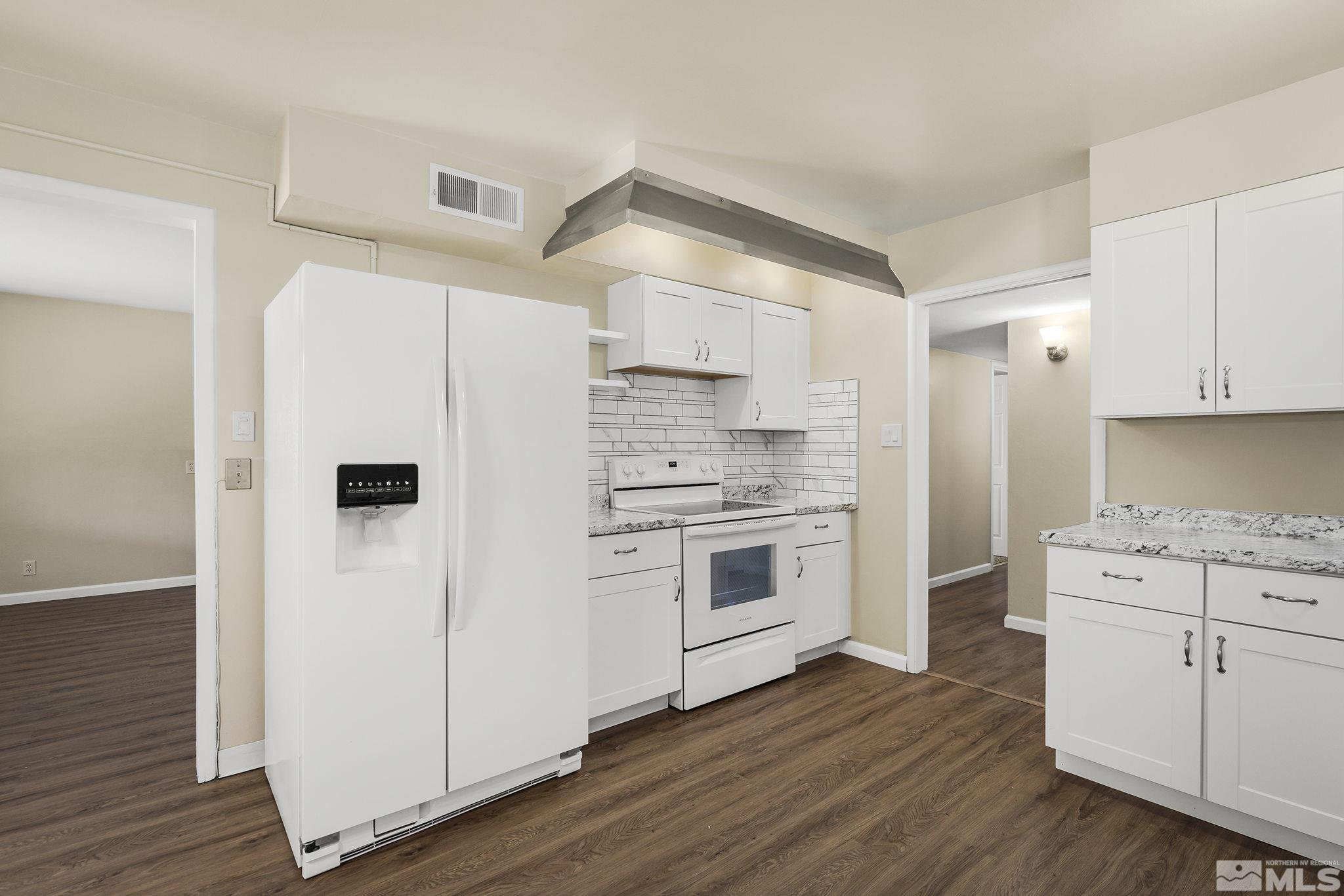 2050 Brisbane Avenue Reno, NV 89503 - Photo 4 of 24 a kitchen with white cabinets and white appliances
