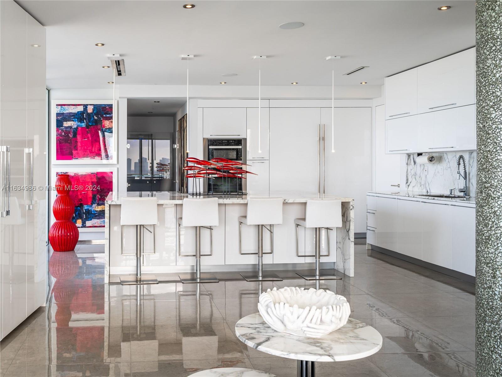 450 Alton Road, Unit PH1 Miami Beach, FL 33139 - Photo 11 of 50 a kitchen with stainless steel appliances kitchen island granite countertop a table and chairs