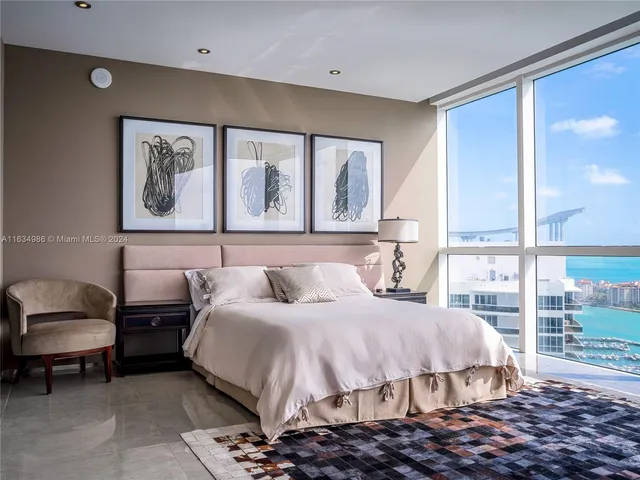 a bedroom with a bed and glass window