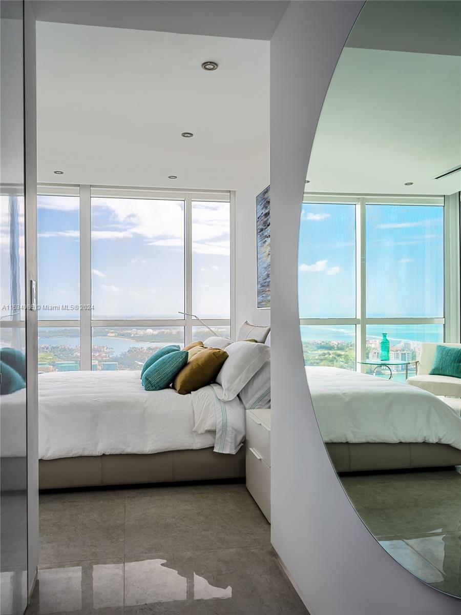 450 Alton Road, Unit PH1 Miami Beach, FL 33139 - Photo 13 of 50 a bedroom with a bed and large window