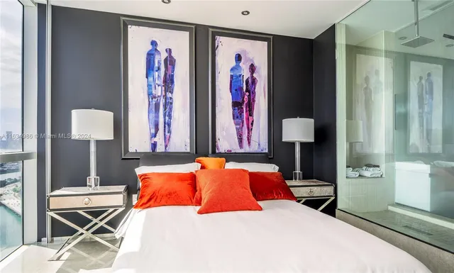 a bedroom with a bed and a lamp