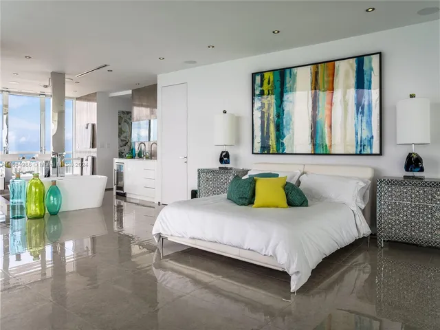 a bedroom with a bed and a large window