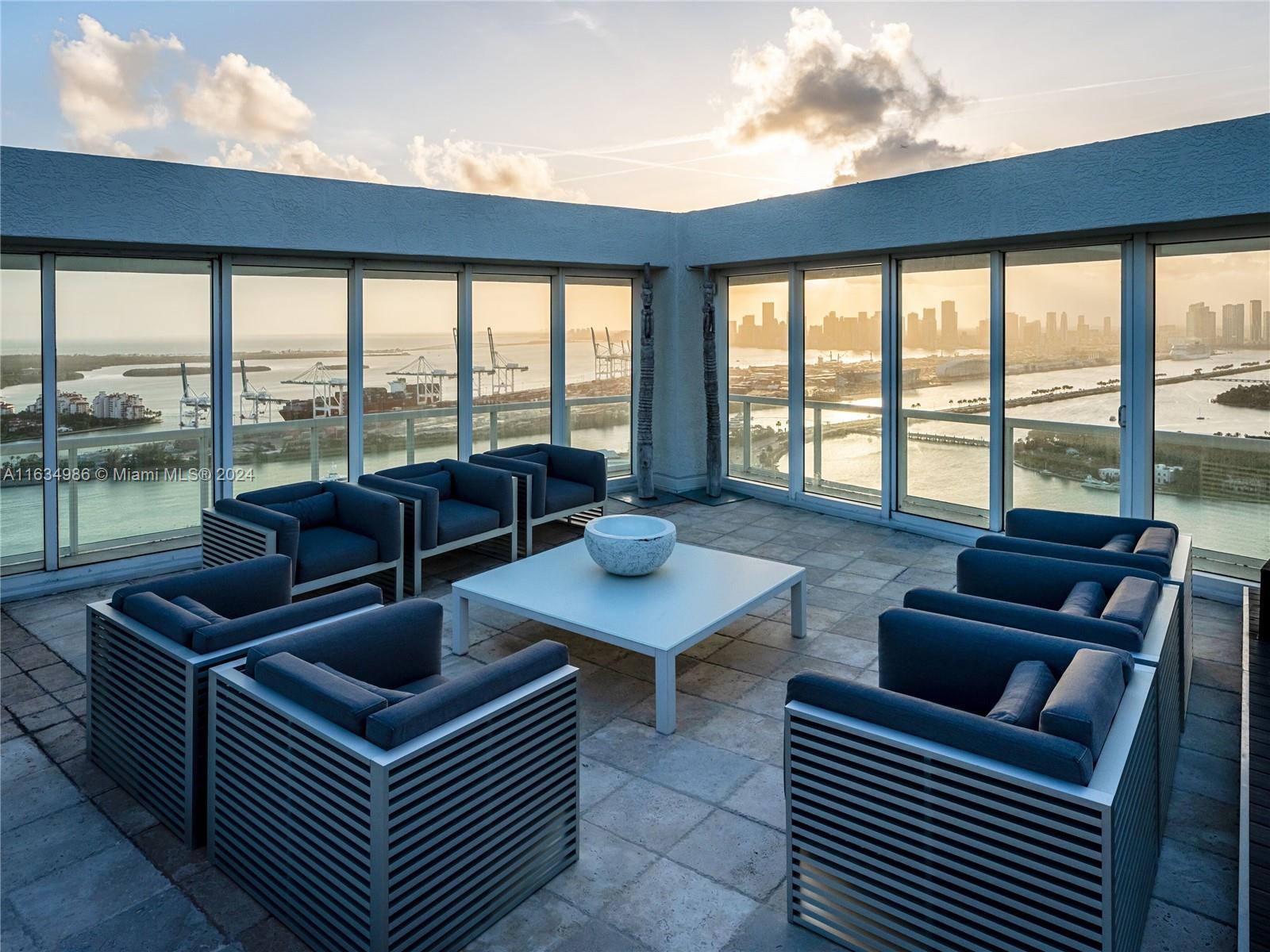 450 Alton Road, Unit PH1 Miami Beach, FL 33139 - Photo 23 of 50 a living room with furniture and a floor to ceiling window