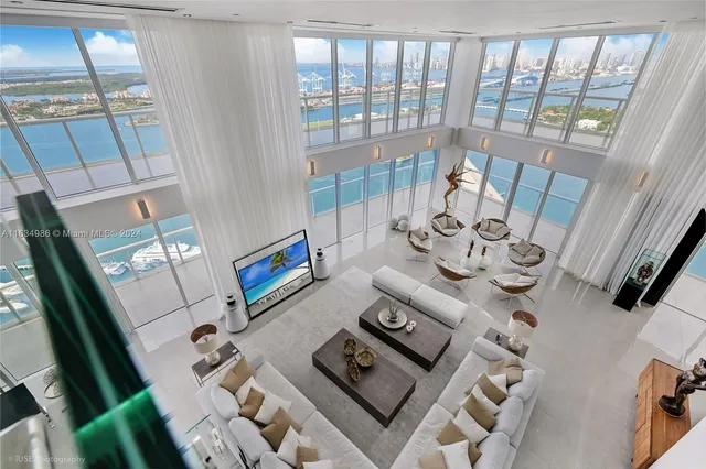 a living room with furniture and a floor to ceiling window