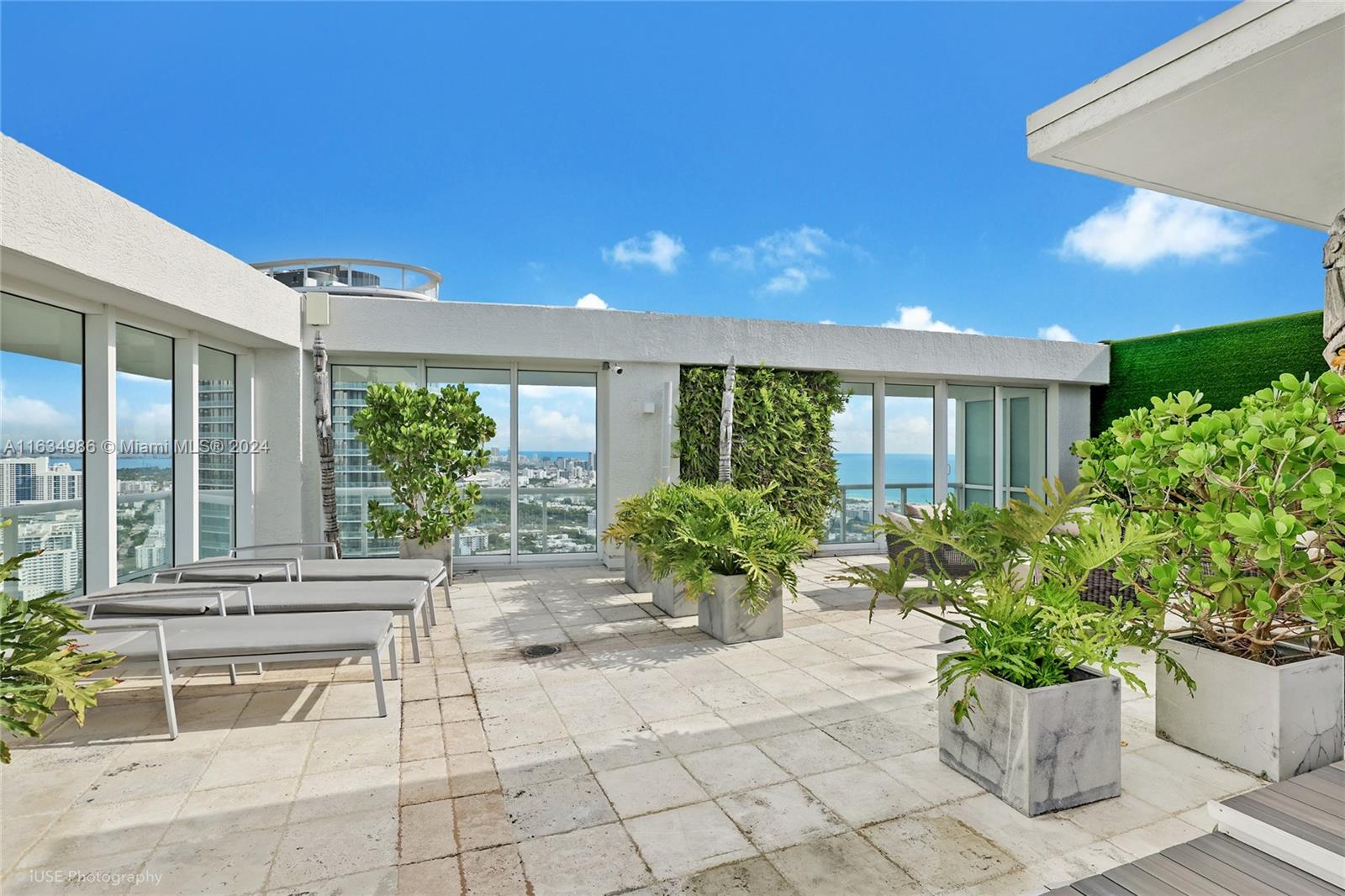 450 Alton Road, Unit PH1 Miami Beach, FL 33139 - Photo 32 of 50 a building with potted plants in front of it