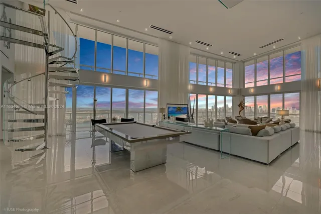 a living room with fireplace furniture and a large window