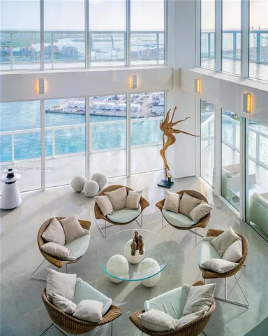 a kitchen with furniture and a large window