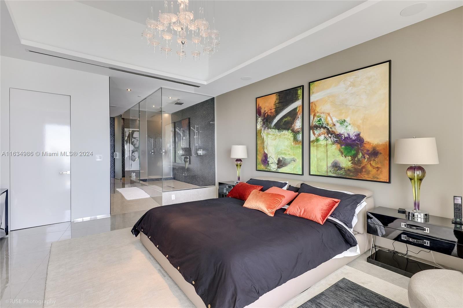 450 Alton Road, Unit PH1 Miami Beach, FL 33139 - Photo 45 of 50 a bedroom with a large bed and a chandelier