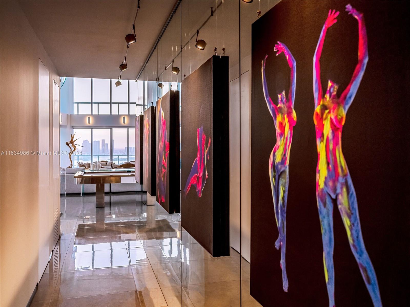 450 Alton Road, Unit PH1 Miami Beach, FL 33139 - Photo 7 of 50 a view of walk in closet with clothes and shoes