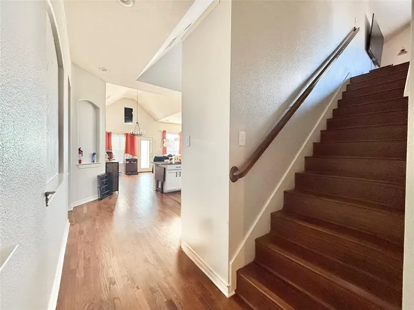 a view of entryway and hall with wooden floor