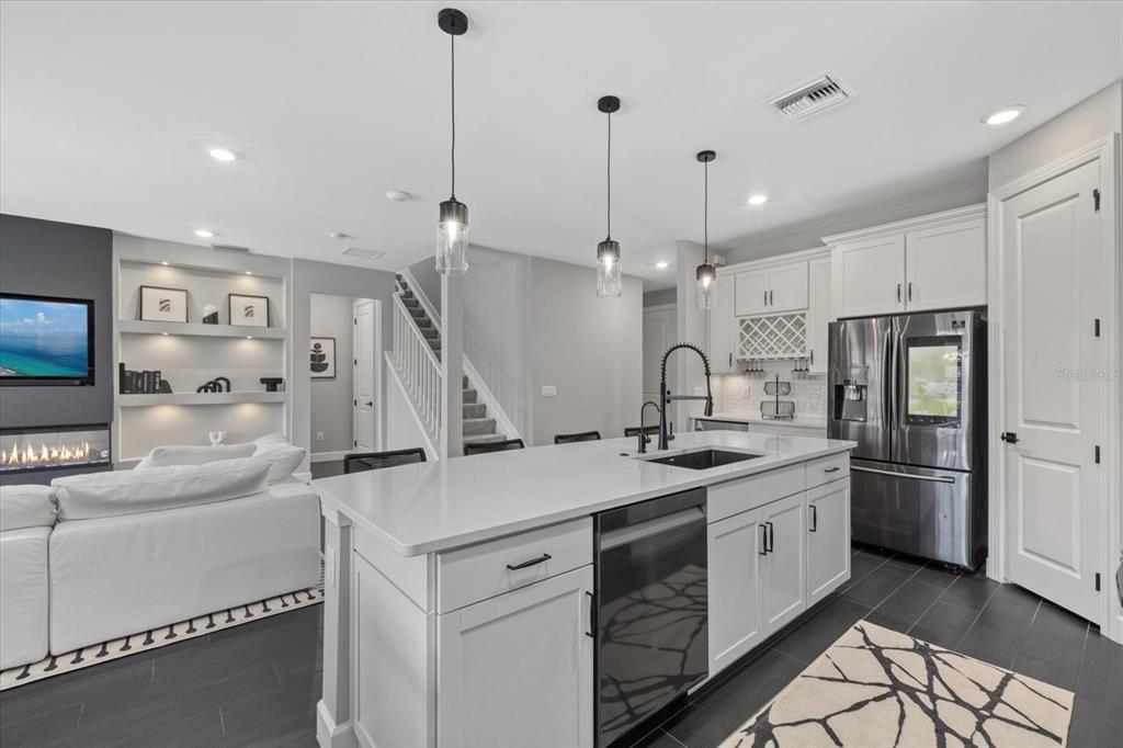 3508 Anchor Bay Trail Lakewood Ranch, FL 34211 - Photo 12 of 74 a kitchen with a sink stainless steel appliances and cabinets