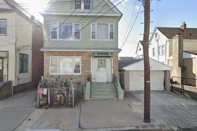 a front view of a building with outdoor seating