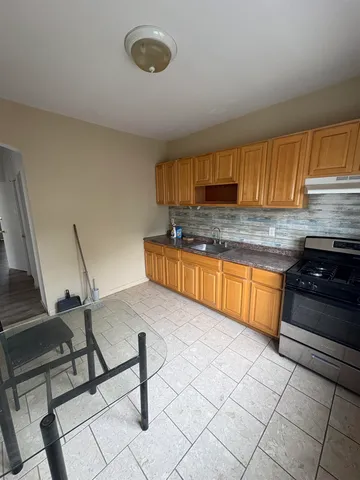 a kitchen with granite countertop a sink cabinets and stainless steel appliances
