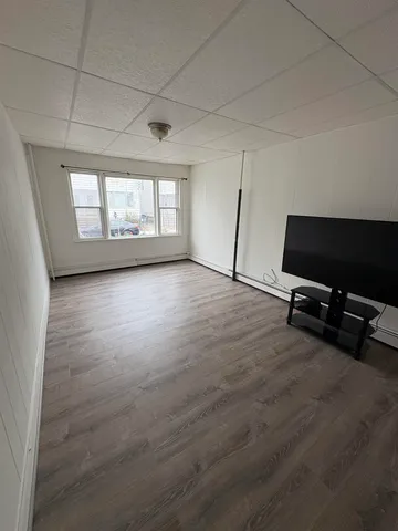 a view of a room with gym equipment and windows