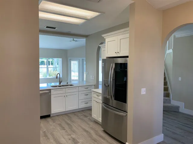 a kitchen with stainless steel appliances a refrigerator sink and cabinets