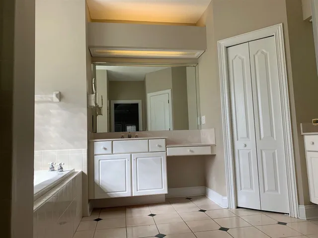 a bathroom with a sink a mirror and a bathtub