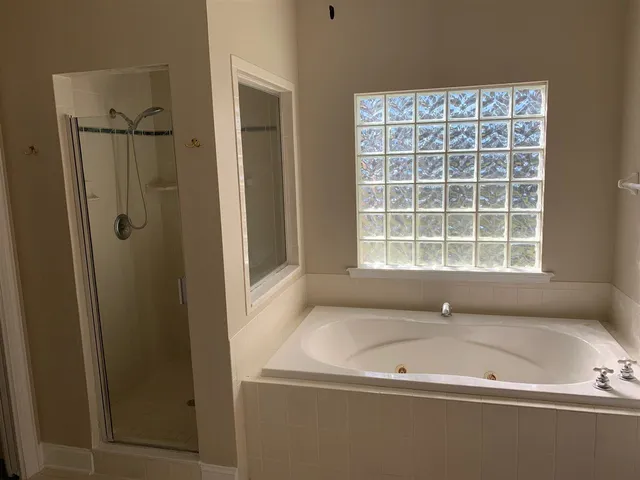 a bathroom with a bathtub and a window
