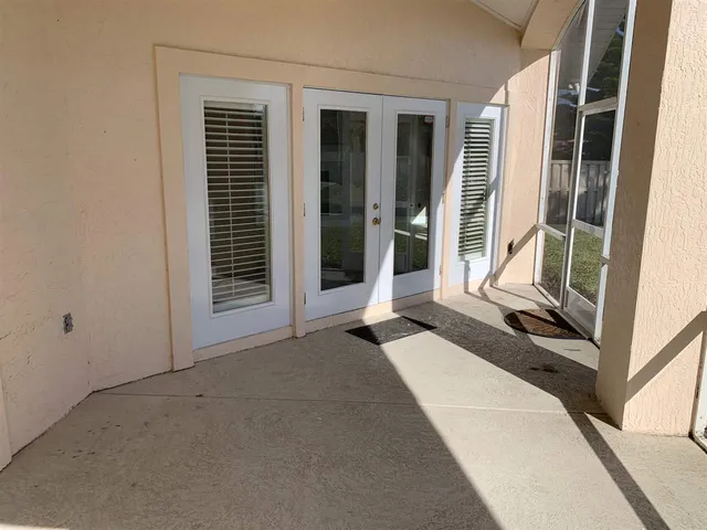 a bedroom with a bed and glass door