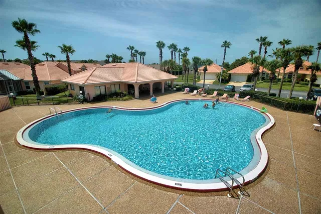 a view of a swimming pool and lounge chair