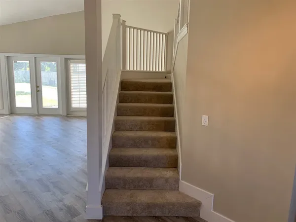 a view of staircase with white walls
