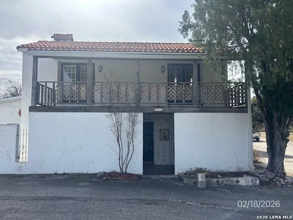a front view of house with a garden