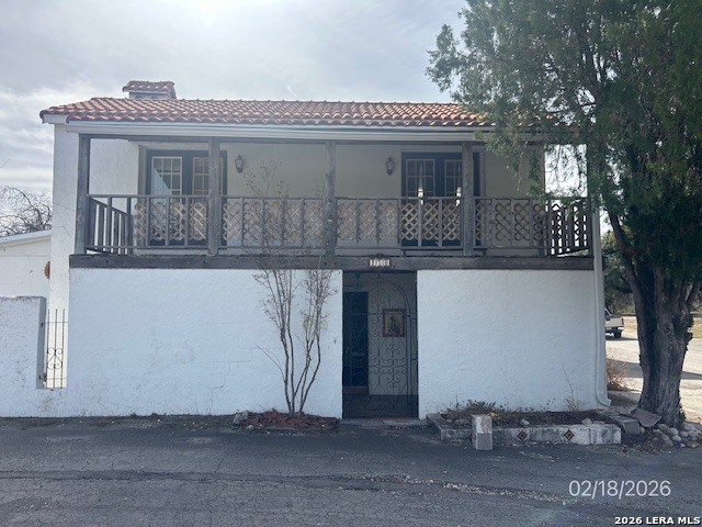 a front view of house with a garden