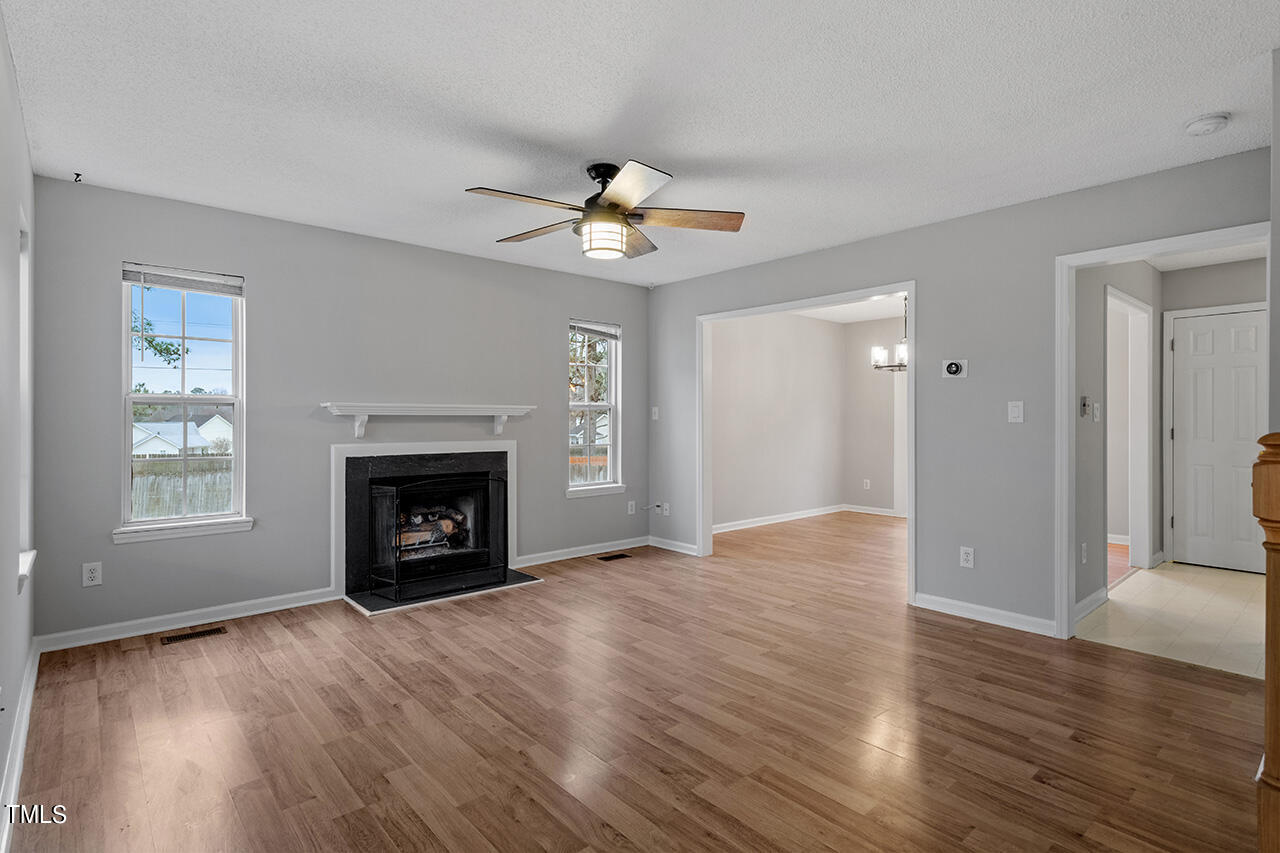 4101 Mardela Spring Drive Raleigh, NC 27616 - Photo 6 of 36 a view of an empty room with a fireplace and a window