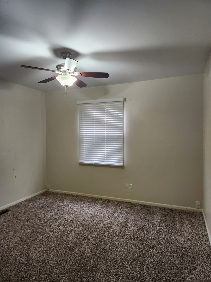 15511 Westminster Drive Orland Park, IL 60462 - Photo 12 of 16 a view of room with a ceiling fan and window