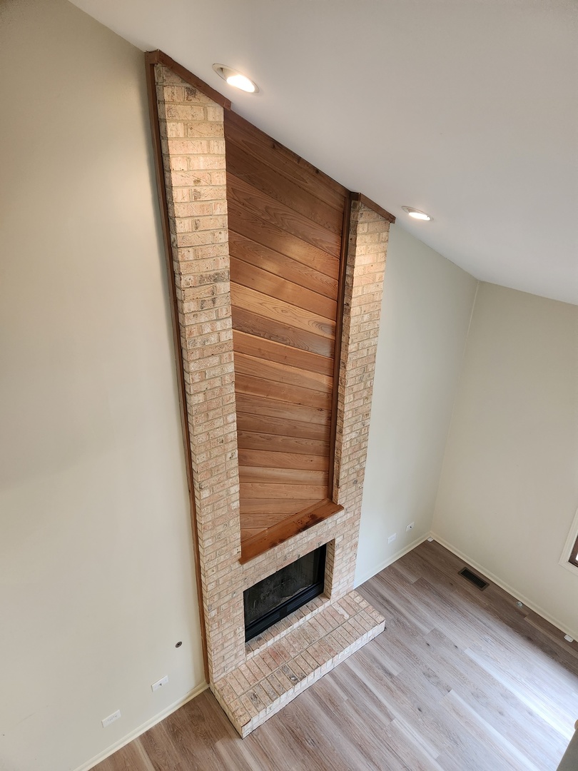 15511 Westminster Drive Orland Park, IL 60462 - Photo 3 of 16 a view of an empty room with wooden floor and a window