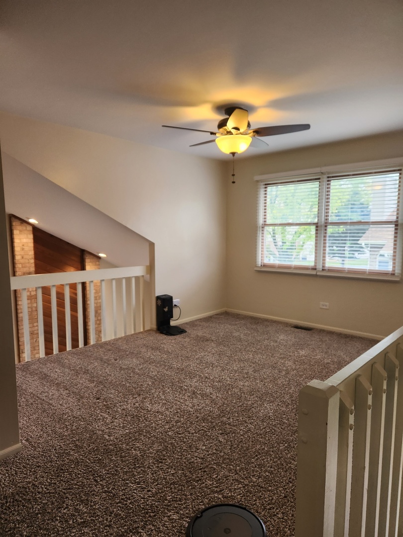15511 Westminster Drive Orland Park, IL 60462 - Photo 10 of 16 a view of a livingroom with a ceiling fan and window