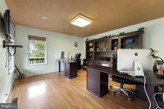 a dining room with furniture wooden floor and a rug