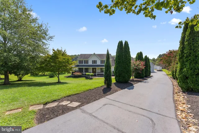 a view of a garden with a house in the background