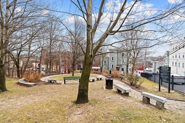 a view of a large white house with a yard and sitting area
