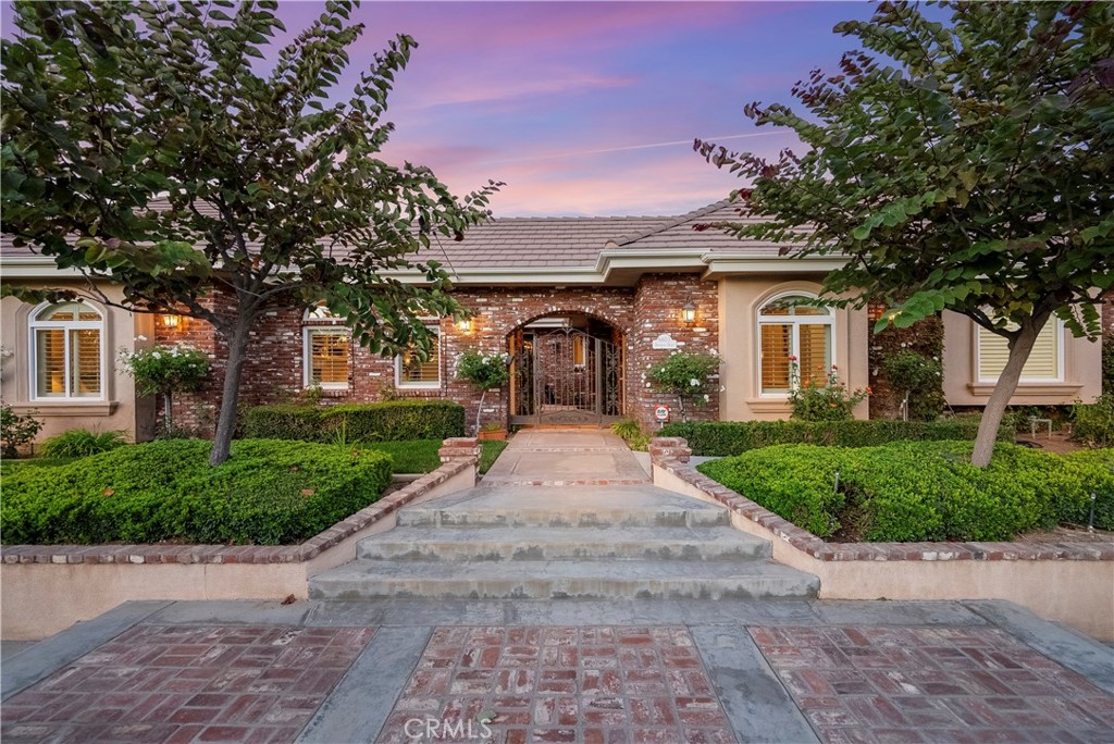 6603 Hawarden Drive Riverside, CA 92506 - Photo 1 of 1 a front view of a house with a yard and a garage