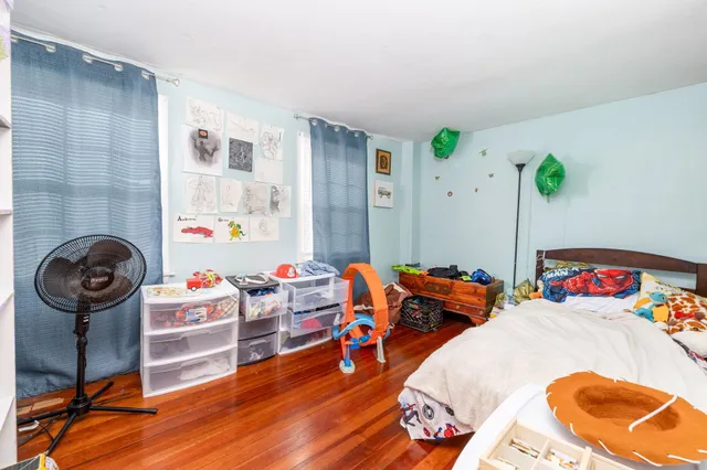 a bedroom with furniture and a wooden floor
