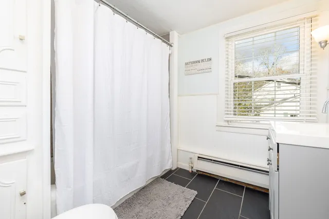 a bathroom with a window and a shower
