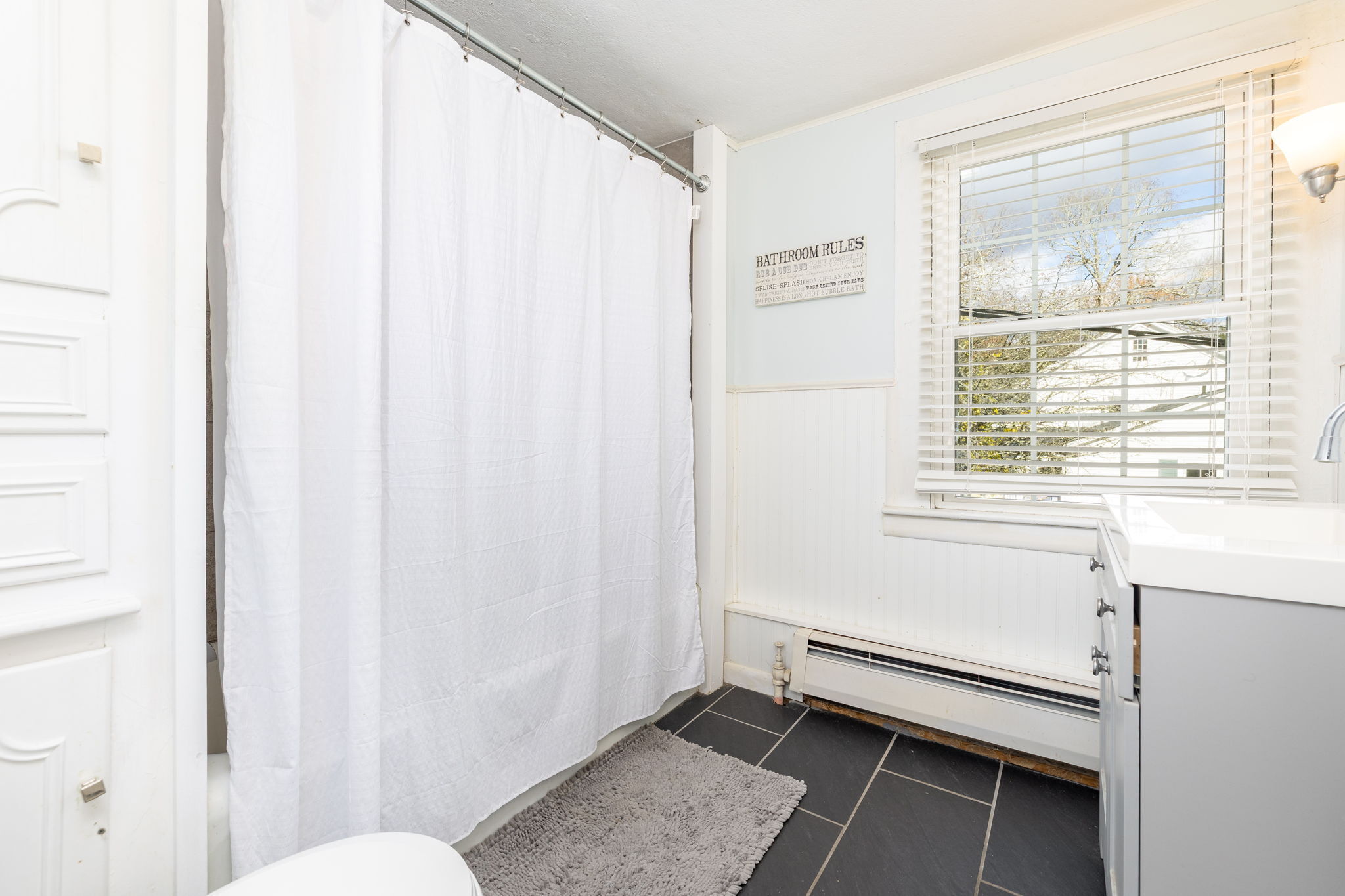409 Main Street Killingly, CT 06239 - Photo 15 of 39 a bathroom with a window and a shower