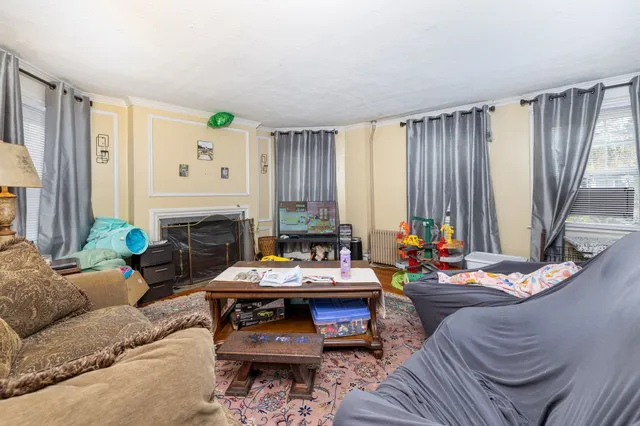 a living room with furniture and a fireplace