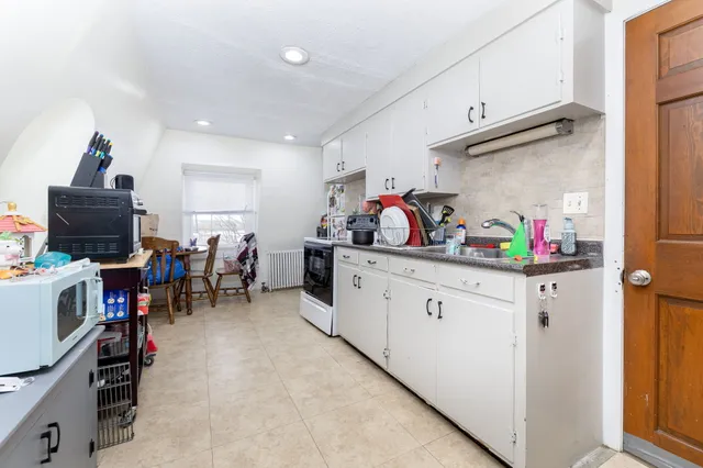 a kitchen with lots of counter top space and furniture