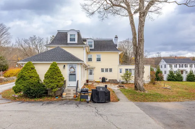 a view of a street with cars parked in front of it