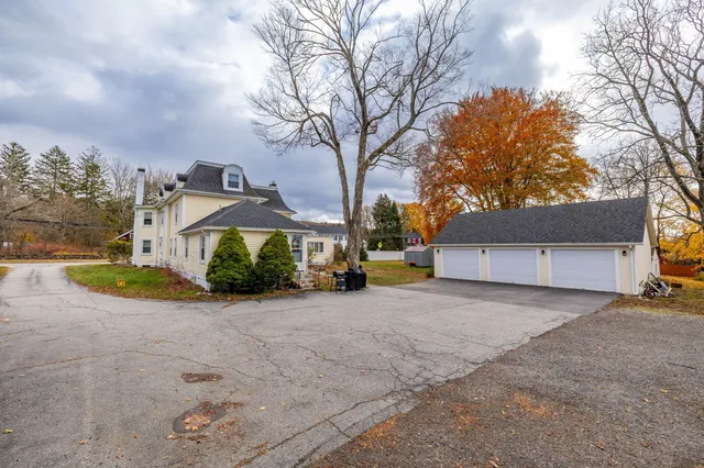 a view of a house with a yard and garage
