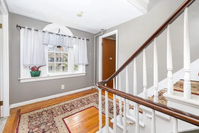 a view of an entryway with wooden floor and stairs