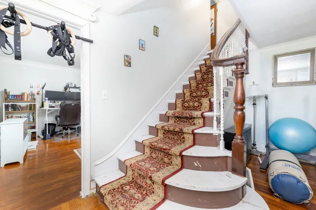 a view of entryway and hall with wooden floor