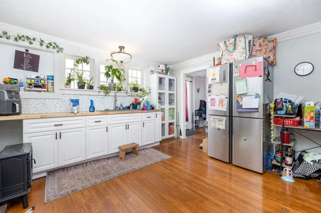 a kitchen that has a lot of cabinets a sink and appliances in it