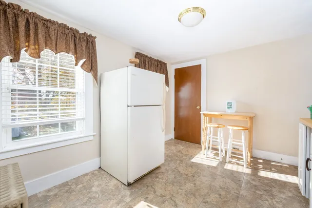 a view of a livingroom with wooden floor and a window