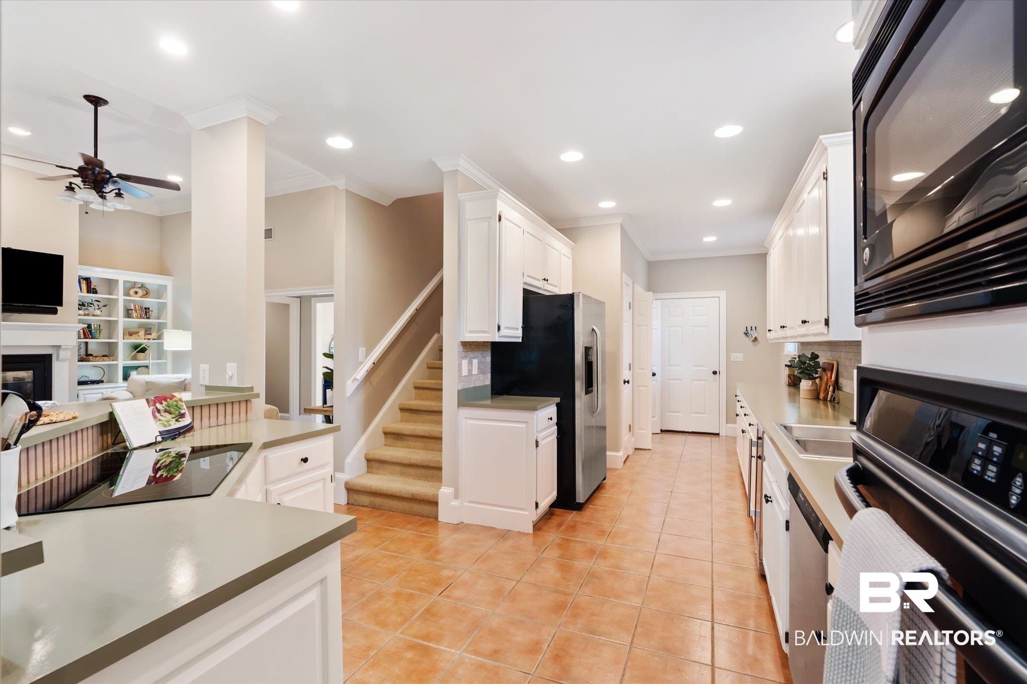 30648 Pine Court Daphne, AL 36527 - Photo 8 of 30 Kitchen featuring light tile patterned floors, white cabinets, ceiling fan, stainless steel appliances, and decorative backsplash
