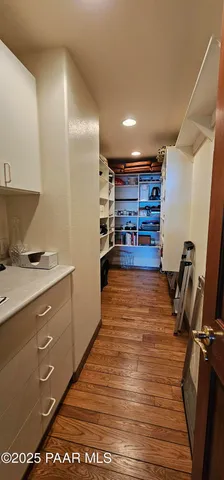 a bedroom with a bed chandelier and window